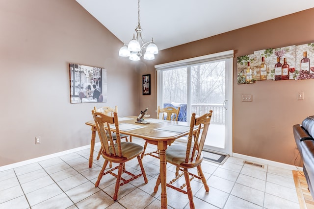 dining area featuring vaulted ceiling, light tile patterned floors, and a chandelier