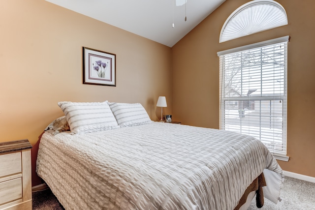 carpeted bedroom featuring lofted ceiling, ceiling fan, and multiple windows