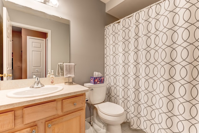 bathroom with tile patterned flooring, vanity, and toilet