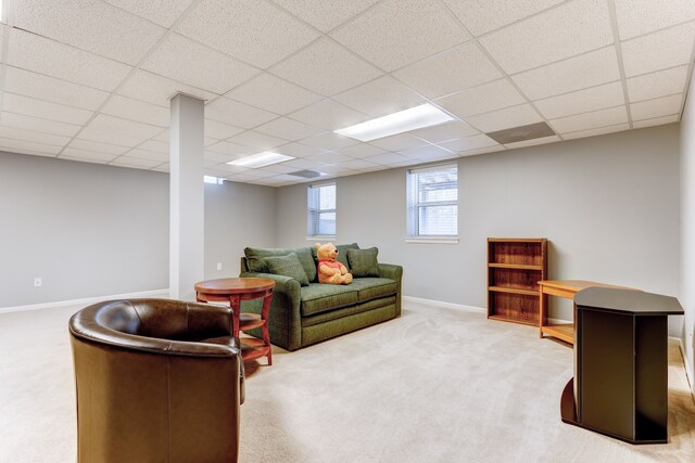 living room with carpet floors and a drop ceiling