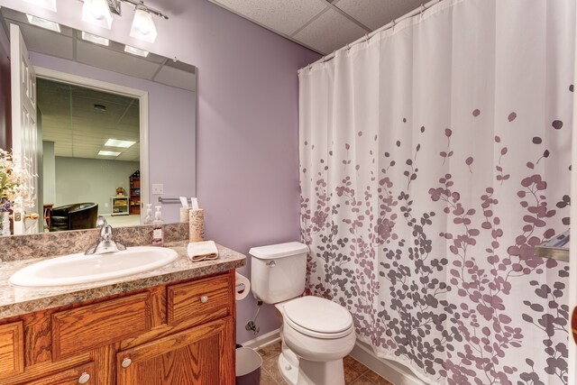 bathroom featuring toilet, tile patterned floors, a paneled ceiling, and vanity