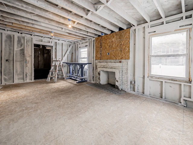 unfurnished living room with a fireplace and a healthy amount of sunlight