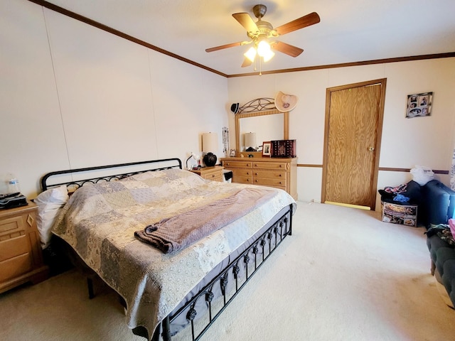 carpeted bedroom featuring ceiling fan and crown molding