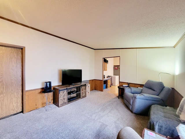 carpeted living room featuring wood walls, a textured ceiling, and crown molding