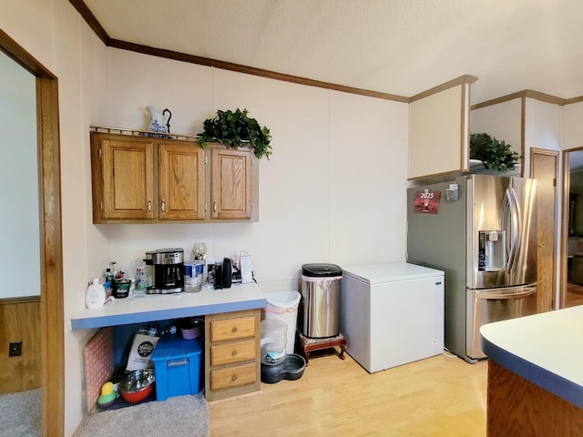 kitchen featuring a textured ceiling, refrigerator, stainless steel fridge with ice dispenser, light hardwood / wood-style floors, and crown molding