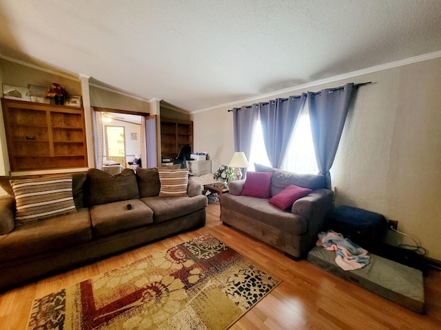 living room with lofted ceiling, a textured ceiling, crown molding, and wood-type flooring