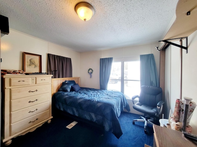 carpeted bedroom featuring a textured ceiling