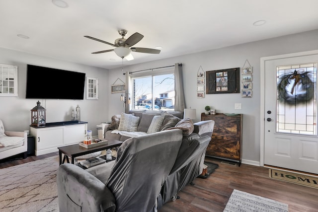 living room with ceiling fan and dark hardwood / wood-style flooring