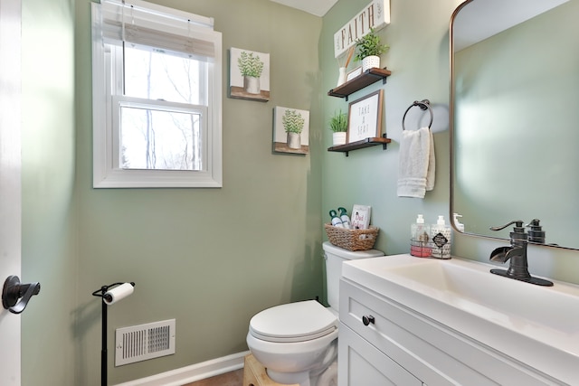 bathroom with toilet and vanity