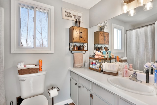 bathroom featuring toilet and vanity