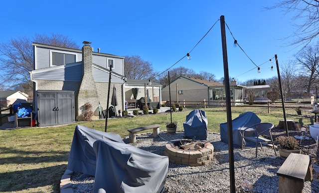 view of yard featuring a storage unit and a fire pit