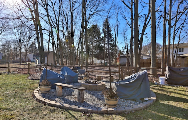 view of yard featuring an outdoor fire pit