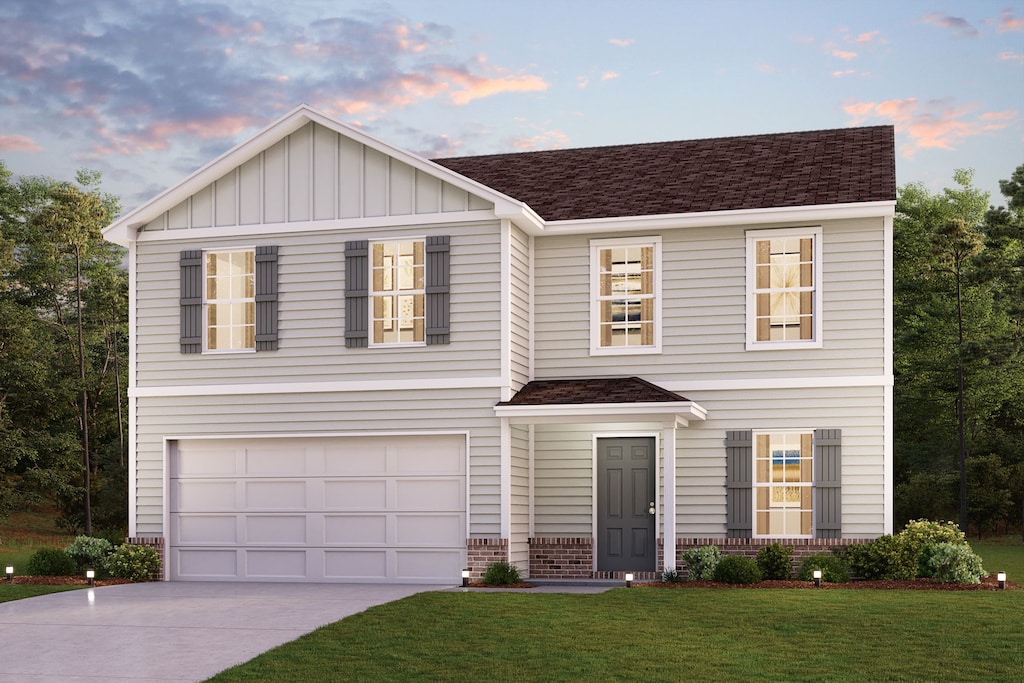 view of front of house featuring a garage and a lawn