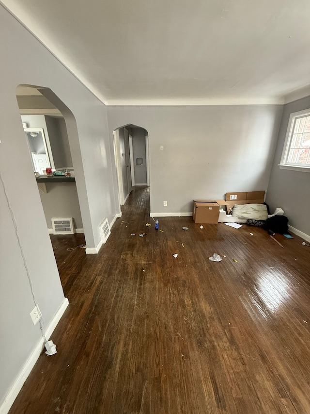 unfurnished living room featuring dark hardwood / wood-style floors