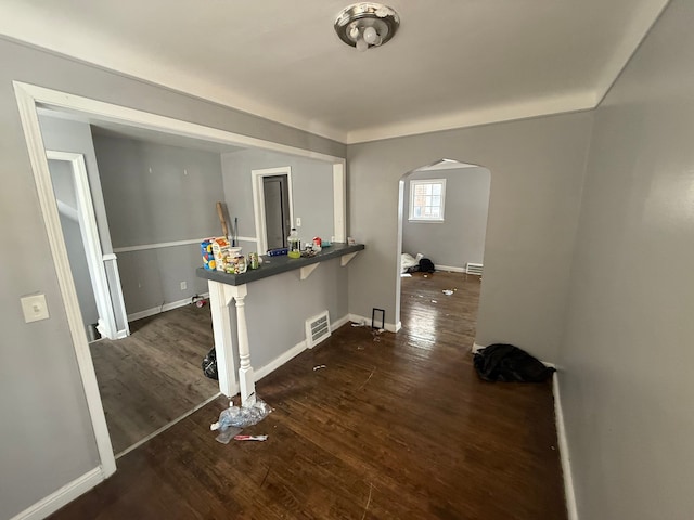 corridor with dark hardwood / wood-style flooring