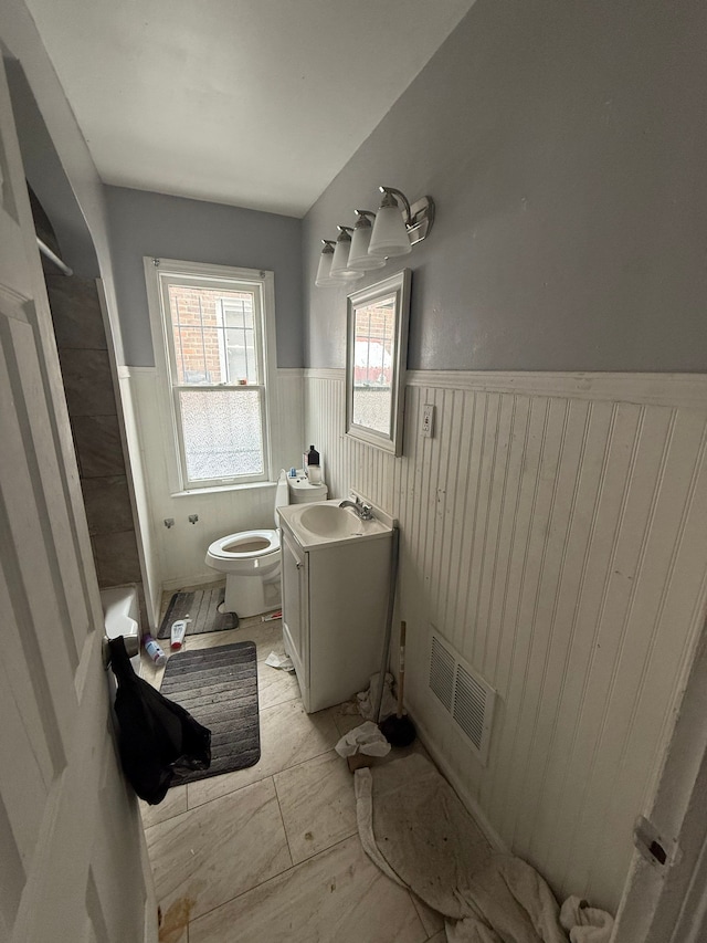 full bathroom with toilet, vanity, and shower / tub combination