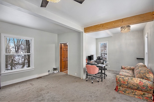 office area featuring ceiling fan, light colored carpet, and beamed ceiling