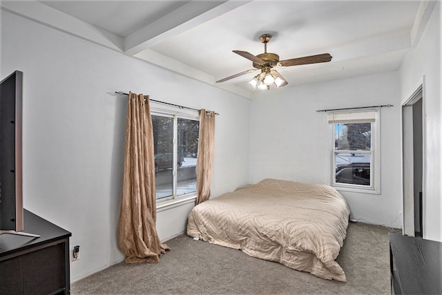 bedroom with ceiling fan, beam ceiling, and carpet floors