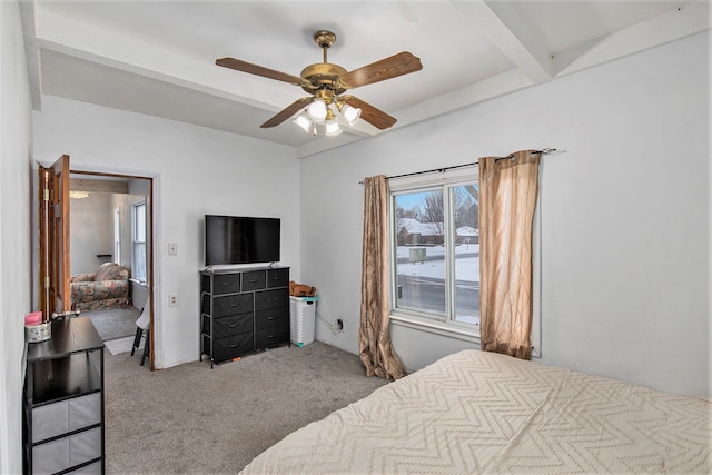 carpeted bedroom featuring ceiling fan and beamed ceiling