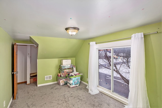 interior space with lofted ceiling and carpet flooring