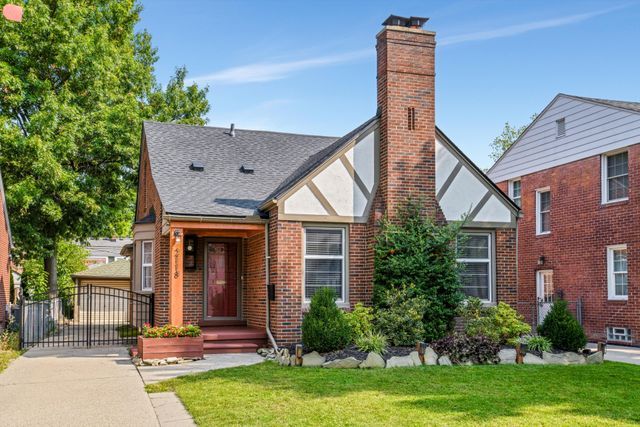 english style home with a front lawn