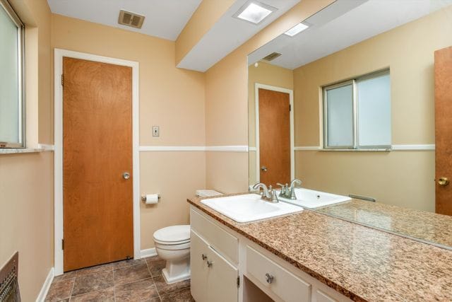 bathroom featuring toilet and vanity