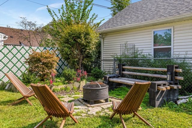 view of yard featuring an outdoor fire pit