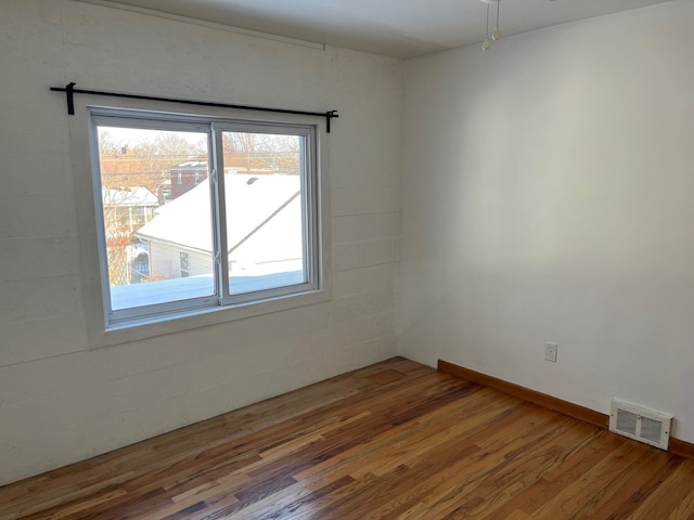 unfurnished room featuring wood-type flooring