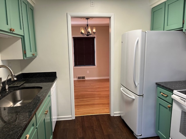 kitchen featuring decorative light fixtures, dark hardwood / wood-style flooring, sink, and green cabinetry