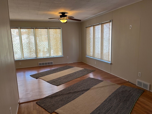 empty room featuring ceiling fan and hardwood / wood-style floors