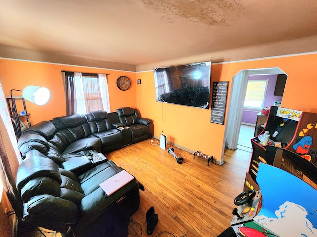 living room with a textured ceiling, plenty of natural light, and hardwood / wood-style flooring