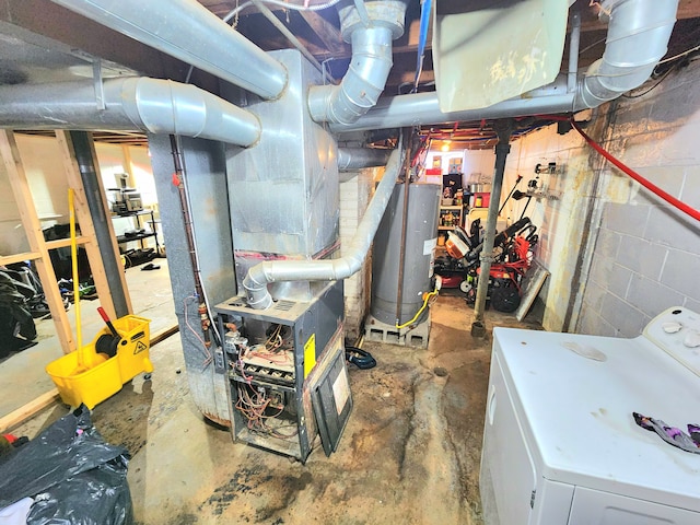 utility room with gas water heater and washer / clothes dryer