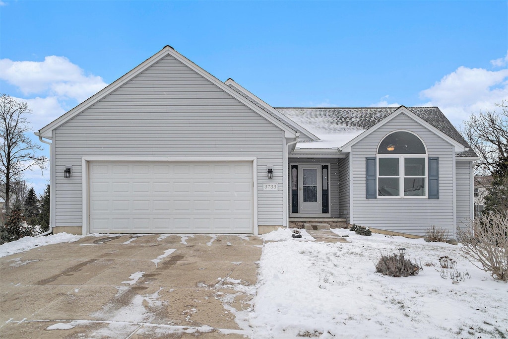 ranch-style home featuring a garage