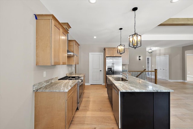 kitchen with a large island, a chandelier, appliances with stainless steel finishes, hanging light fixtures, and sink