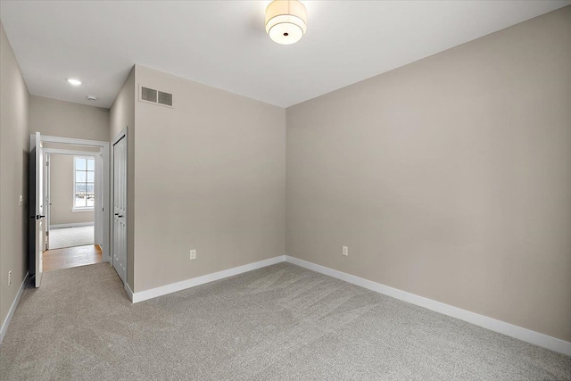 unfurnished room with light colored carpet