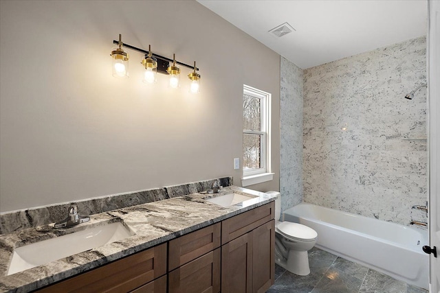 bathroom with toilet, a tub to relax in, and vanity