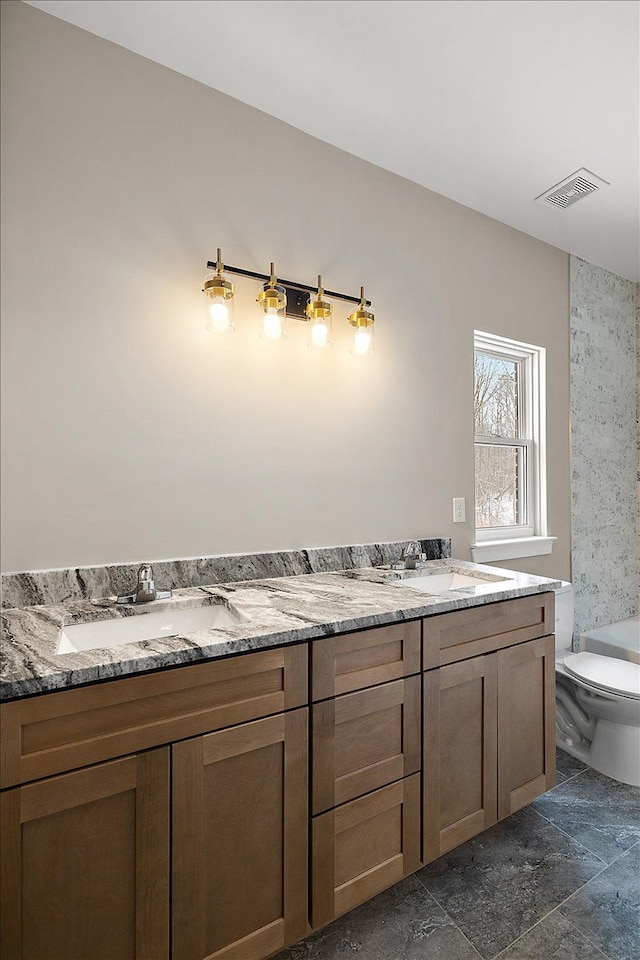 bathroom with toilet and vanity