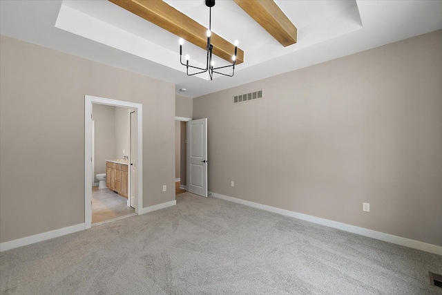 unfurnished bedroom with light colored carpet, an inviting chandelier, ensuite bath, and beamed ceiling