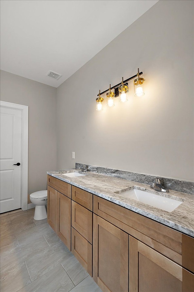 bathroom with toilet and vanity