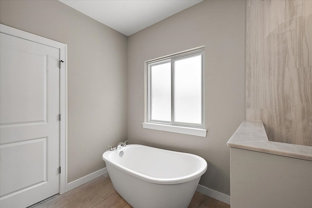 bathroom featuring tile patterned flooring and a tub to relax in