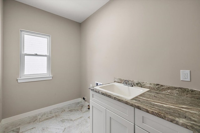 laundry room featuring sink, hookup for a washing machine, and cabinets