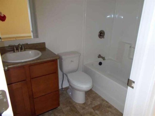 full bathroom featuring toilet, tub / shower combination, and vanity