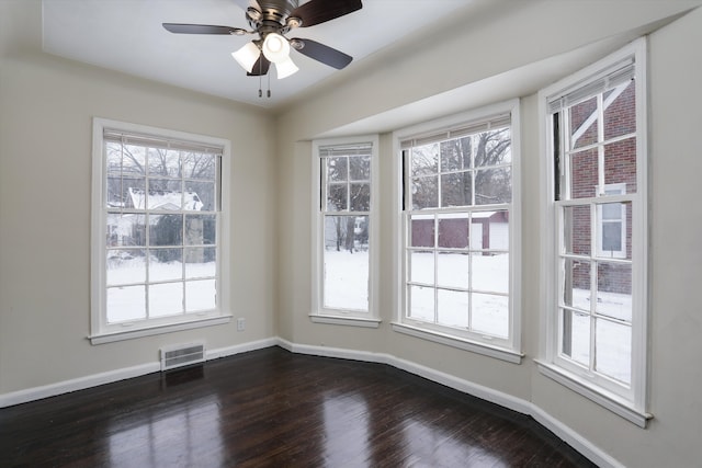 unfurnished dining area featuring dark hardwood / wood-style flooring and ceiling fan