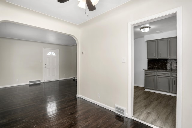 interior space featuring ceiling fan and dark wood-type flooring