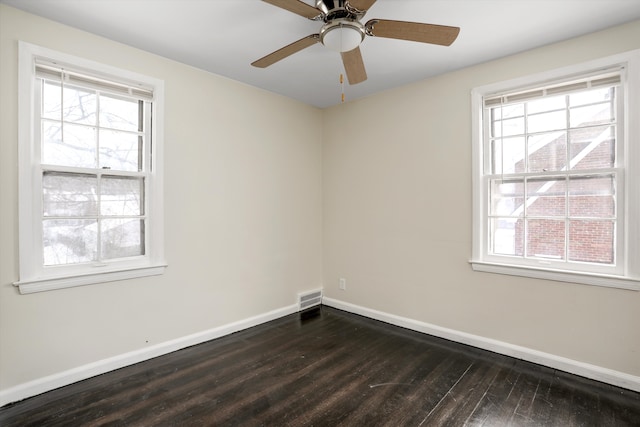 empty room with dark wood-type flooring and ceiling fan