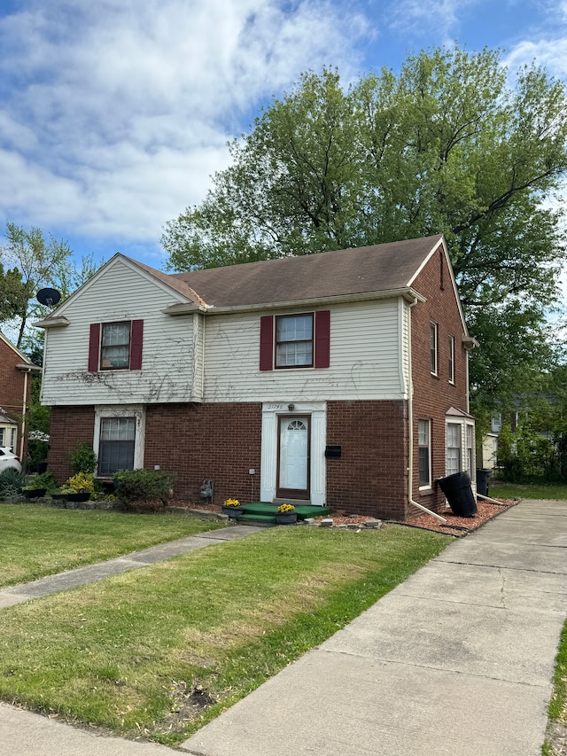 21746-48 Moross Rd, Grosse Pointe, MI 48236 - view of front of house featuring brick siding and a front yard