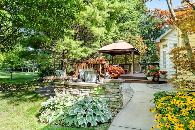 view of patio / terrace with a gazebo, a deck, and a bar