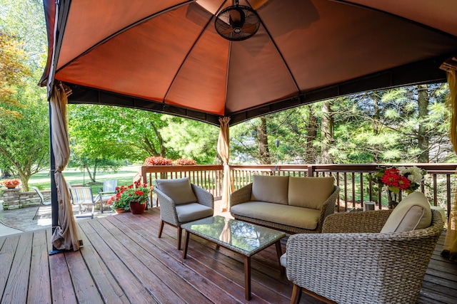 wooden terrace with a gazebo and an outdoor living space