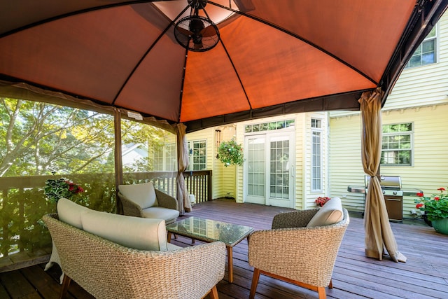 wooden deck with a gazebo and grilling area