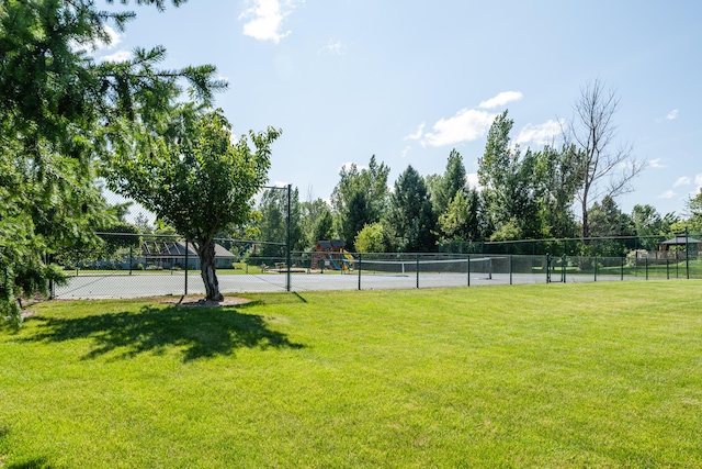 view of home's community with a yard and a playground